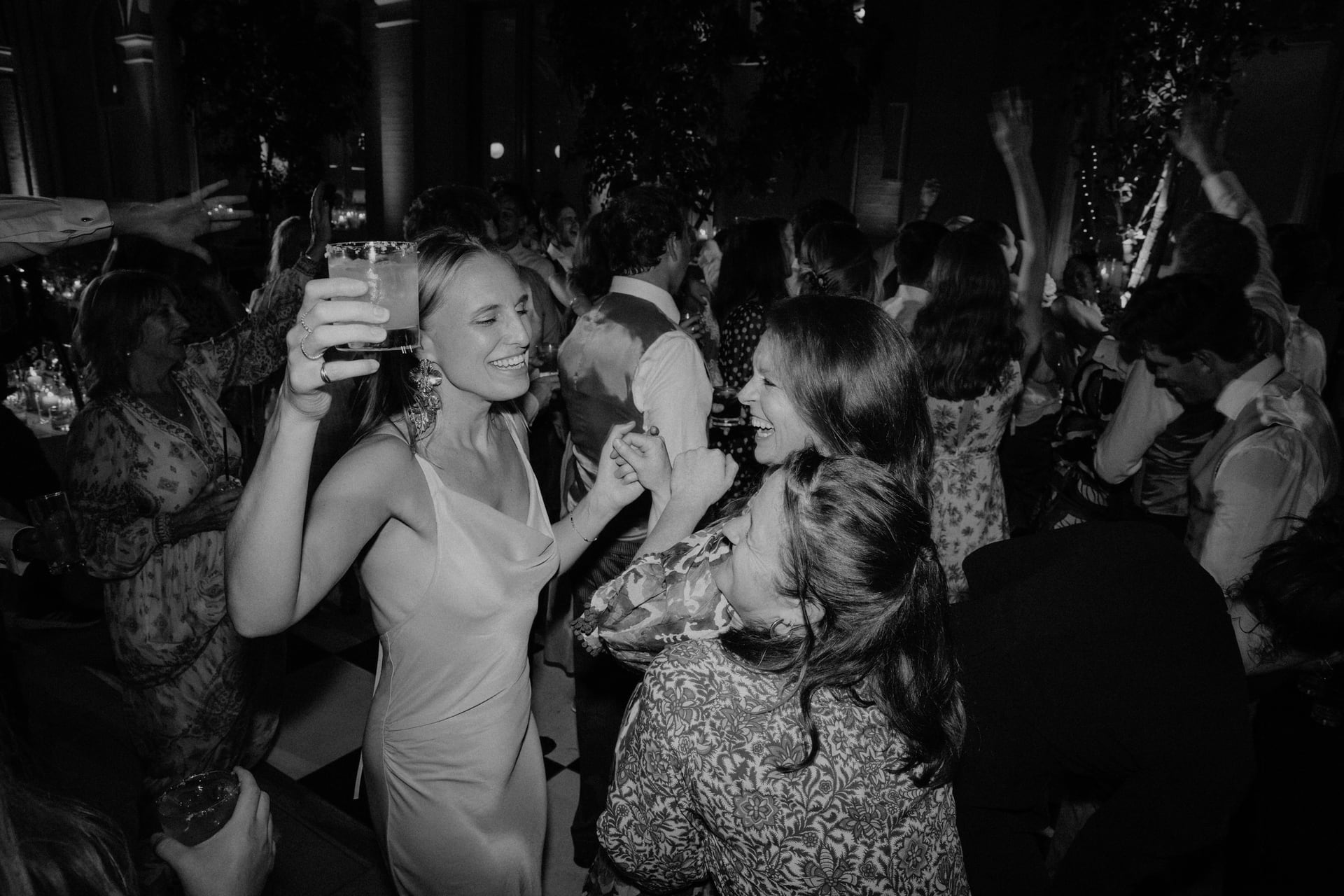 Guests dancing close to the band, in black and white